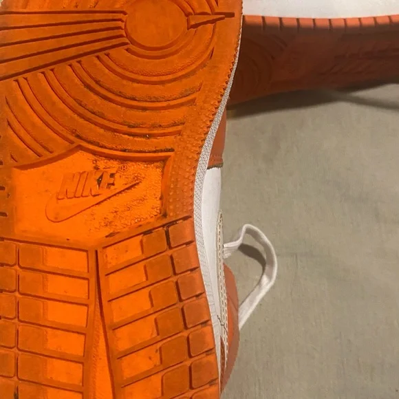 Nike mid 1 orange and white air Jordan.